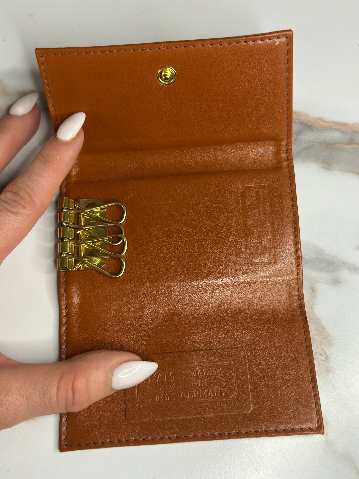 Pre-owned MCM key holder in cognac Visetos monogram canvas with brown leather interior