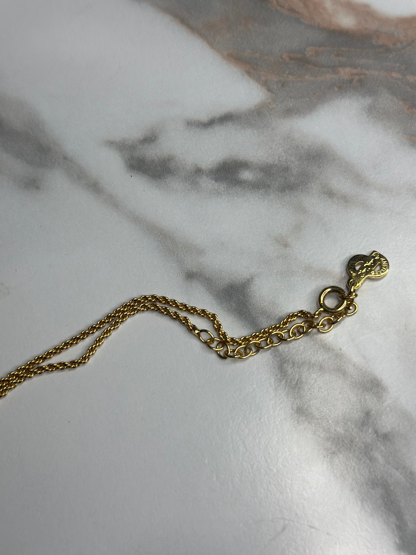 Pre-owned Christian Dior vintage necklace features a gold-tone teardrop pendant set with black enamel and crystals