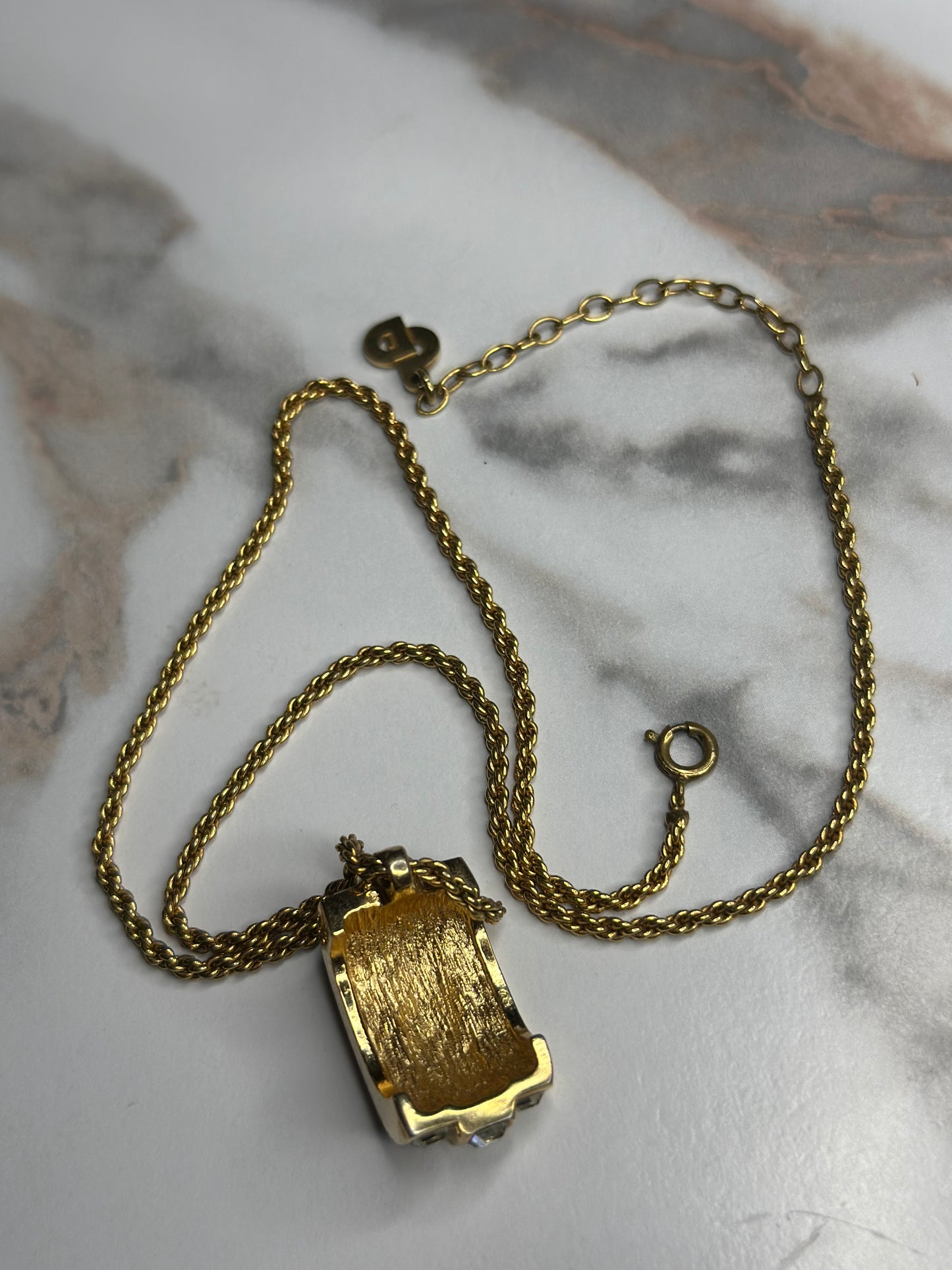 Pre-owned Christian Dior vintage necklace features a gold-tone chain and a cylindrical pendant