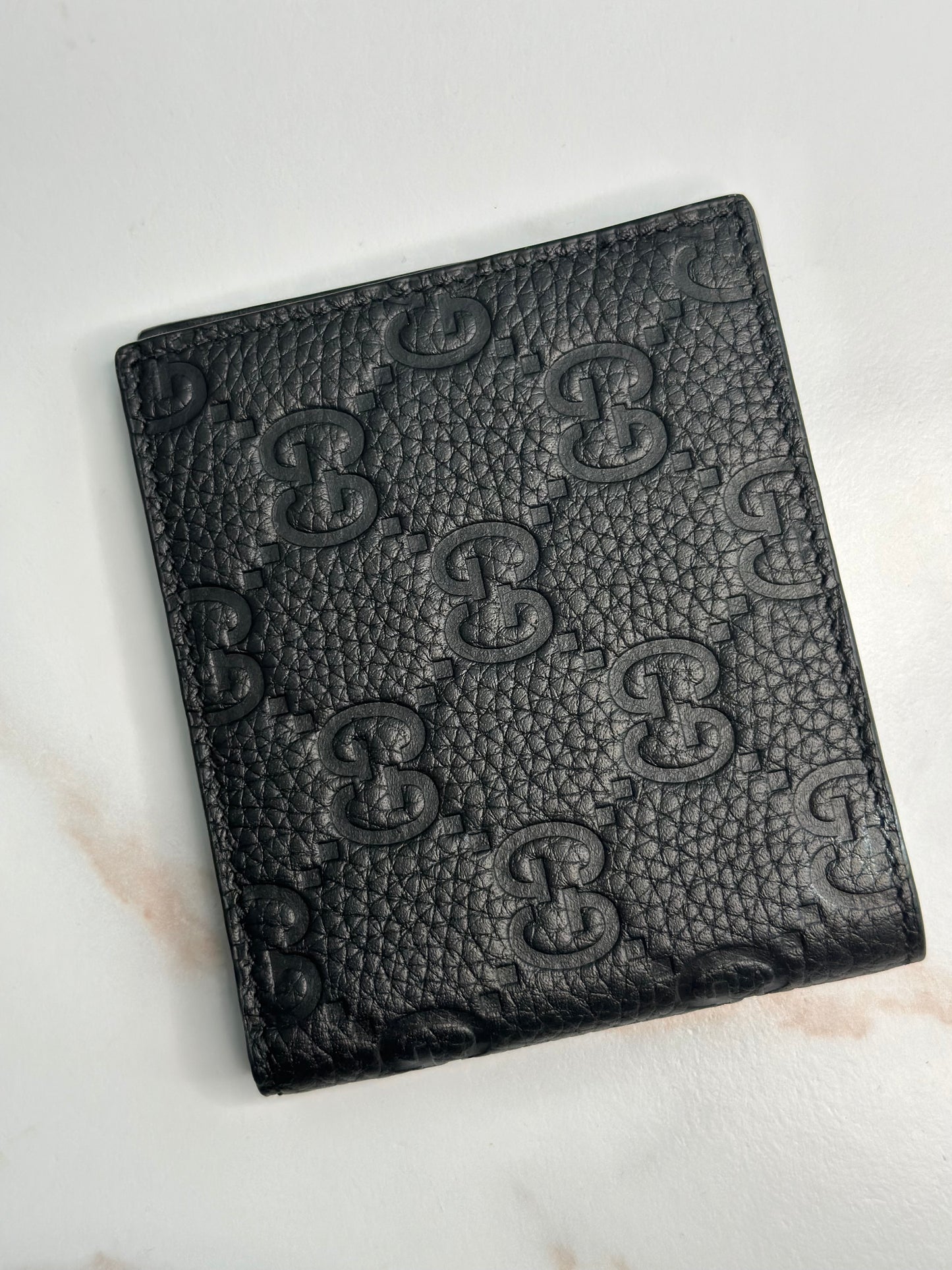 Pre-owner Gucci GG embossed black bifold wallet