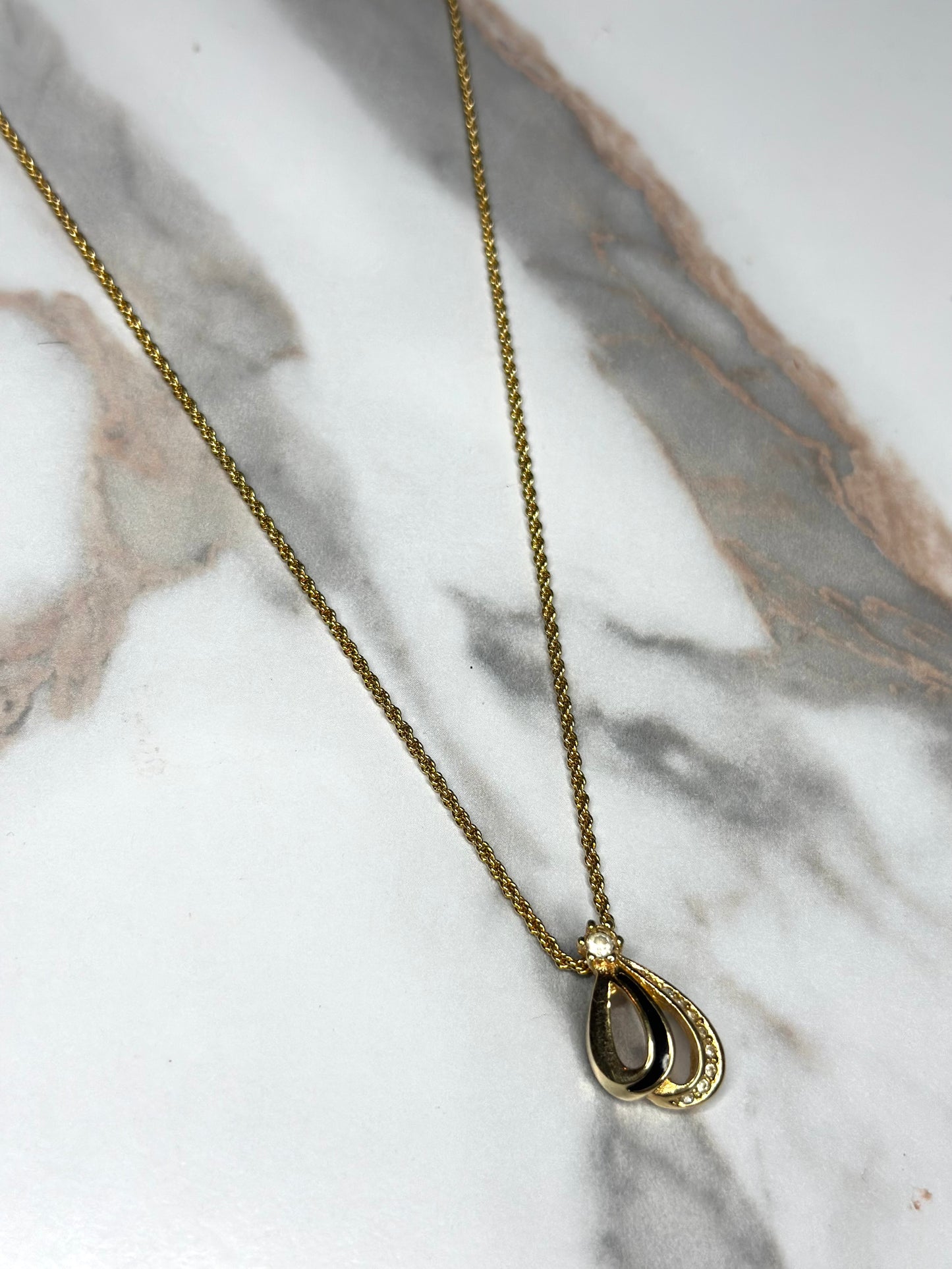 Pre-owned Christian Dior vintage necklace features a gold-tone teardrop pendant set with black enamel and crystals