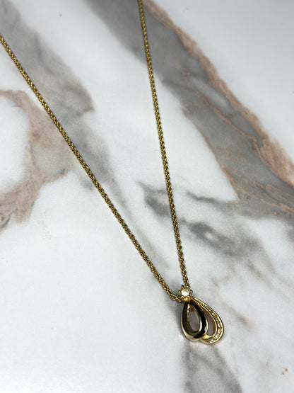Pre-owned Christian Dior vintage necklace features a gold-tone teardrop pendant set with black enamel and crystals