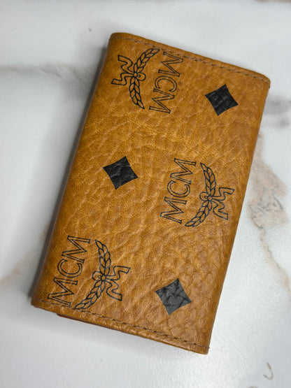 Pre-owned MCM key holder in cognac Visetos monogram canvas with brown leather interior