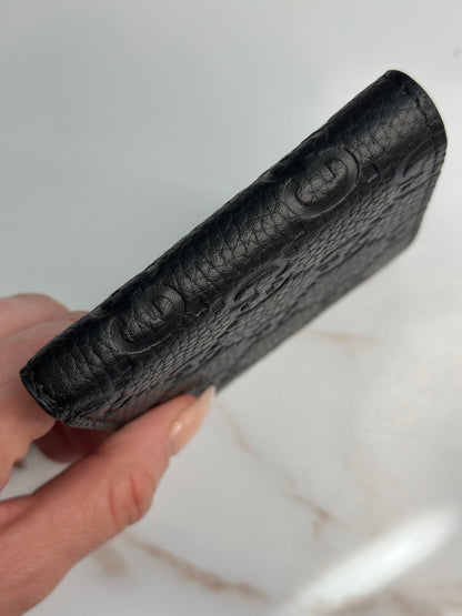 Pre-owner Gucci GG embossed black bifold wallet