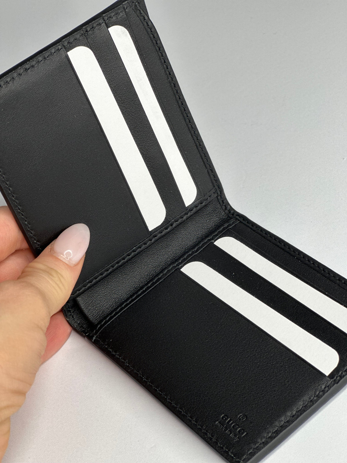 Pre-owned Gucci GG embossed black leather bifold wallet