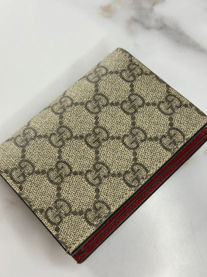 Pre-owned Gucci GG Supreme canvas bifold or compact wallet with a cherry embellishment.