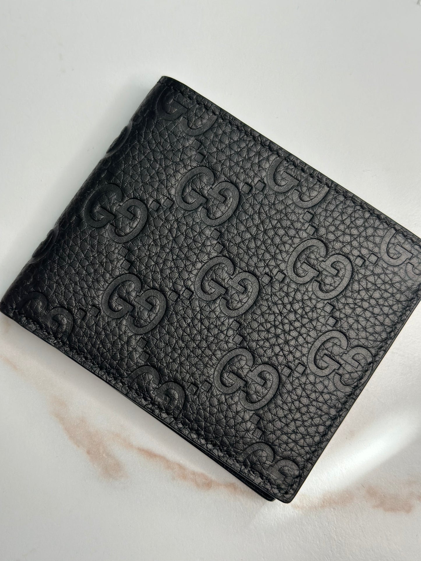 Pre-owner Gucci GG embossed black bifold wallet