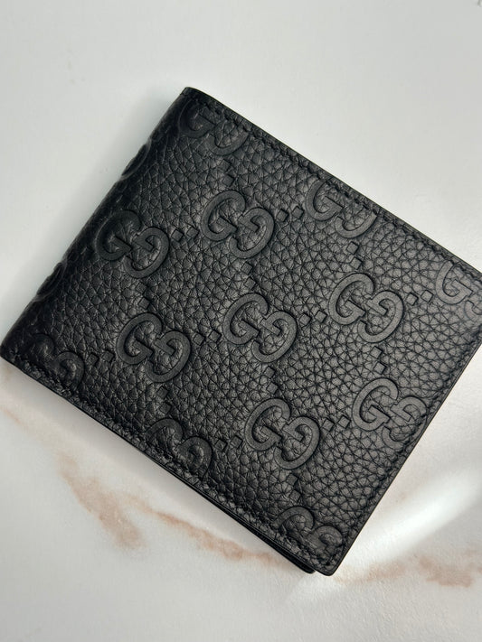 Pre-owner Gucci GG embossed black bifold wallet