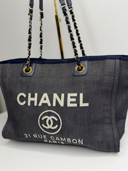 Pre-owned Chanel Deauville tote bag crafted in blue denim with gold-tone hardware medium tote